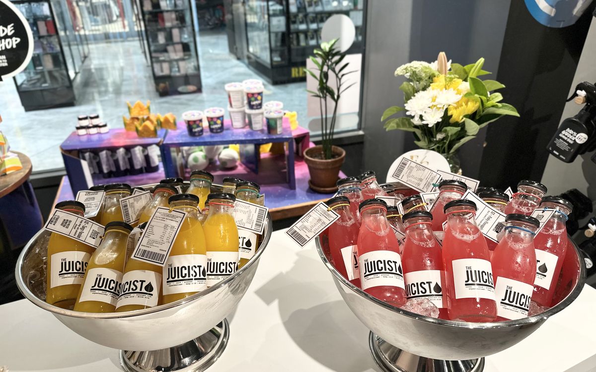 Branded Juicist drinks displayed in silver bowls at a corporate activation